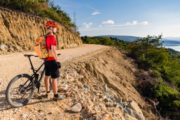 Mountain biker riding on bike at the sea