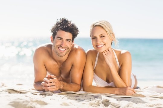 Young Couple Lying On Beach