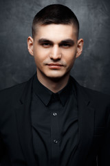 Obraz premium Portrait of handsome man in a black suit.