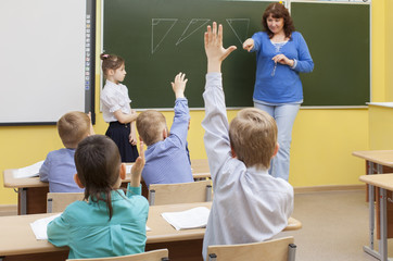 Beautiful caucasian teacher on a lesson in primary school classr