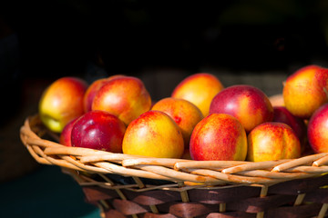 Nectarines in wooden basket nuts