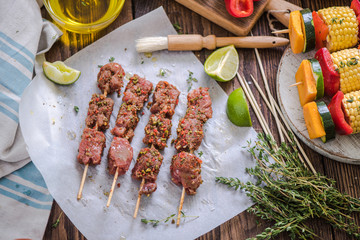 marinate beef skewers on wooden table