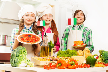 Three cooks with traditional Italian food products
