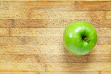 Green apple on cutting board