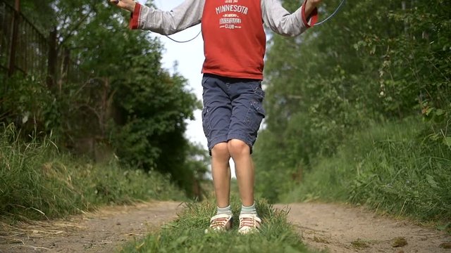 boy jumping rope outdoors have fun