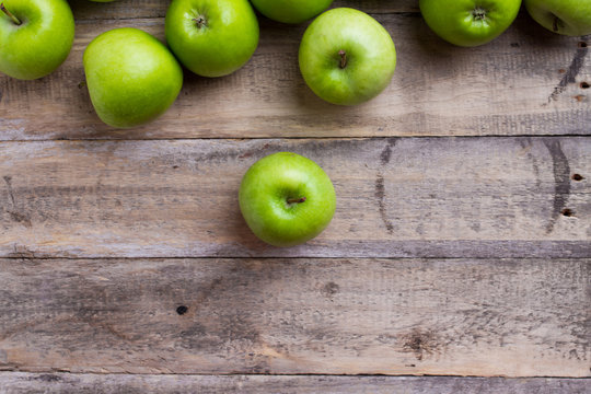 green apples on wood - top view