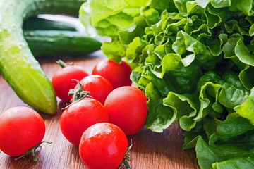 Vegetables. Tomato, cucumber, green salad wooden