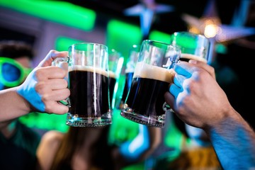 Group of friends toasting beer mugs