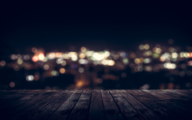 Wooden plank above the town at night