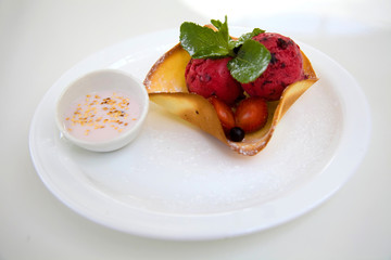 Red ice cream scoops with wafer bowl on white background