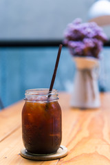 Iced Americano black coffee on a wooden table