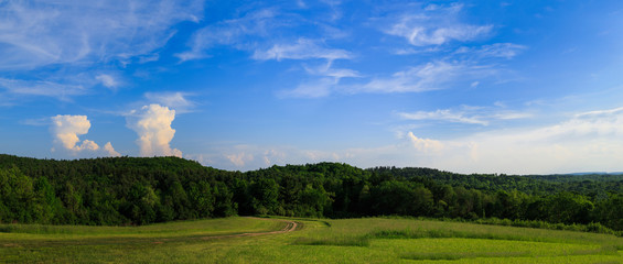 Green pasture and sunny day in Hudson Valley NY over looking mou