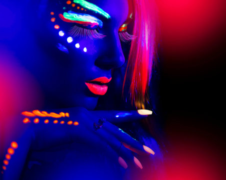 Fashion model woman in neon light, portrait of beautiful model girl with fluorescent make-up