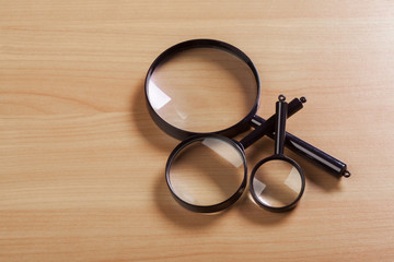 magnifying glass on the wooden background