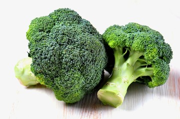Organic broccoli on a white wooden background