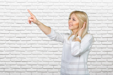 Young blond businesswoman pressing the touchscreen button