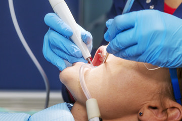 Dentist making patient's teeth hygiene