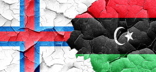 faroe islands flag with Libya flag on a grunge cracked wall