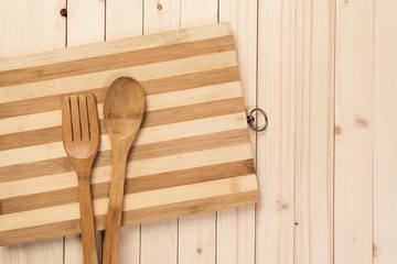 Wooden spoon and fork on wood texture