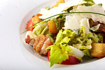Fresh salad with grilled meat, quail  eggs and parmesan on a white background