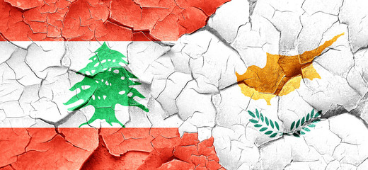 Lebanon flag with Cyprus flag on a grunge cracked wall