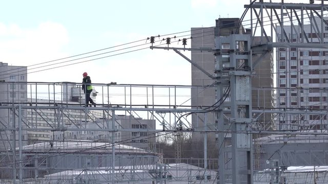 Distant worker checking railroad infrastructure