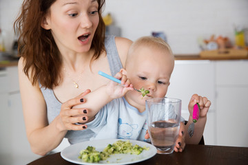 Mother and child eating together and have fun