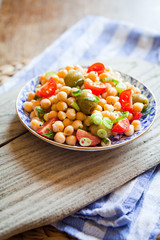 Mediterranean salad board - cherry tomatoes, green olives, chickpea.