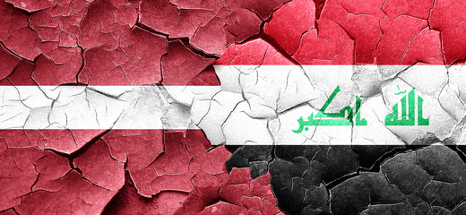 Latvia flag with Iraq flag on a grunge cracked wall