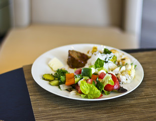 Lunch at the hotel. A fresh vegetable salad. Business lunch. The hotel is five stars. Main dishes. Salad on the table

