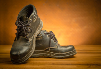 safety shoes black color on the wooden floor with  copy space