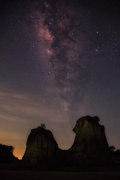 Landscape with Milky Way. Night sky with stars and silhouette of rock mountains.