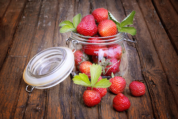 strawberries in a jar on the old wooden background shabby rustic retro style