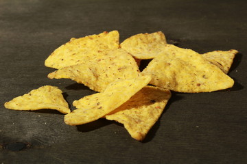 tortilla chips on black wood background