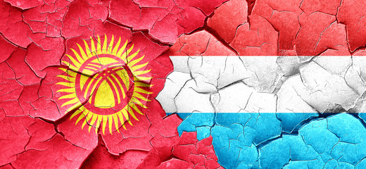 Kyrgyzstan flag with Luxembourg flag on a grunge cracked wall