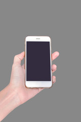 businessman's hand holding the white smartphone with blank screen on gray background
