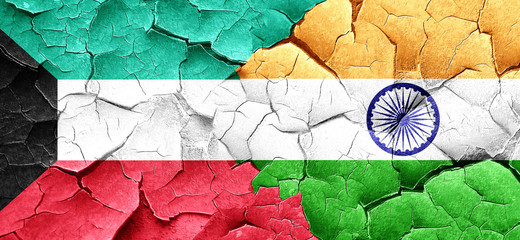 Kuwait flag with India flag on a grunge cracked wall