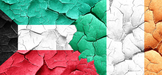 Kuwait flag with Ireland flag on a grunge cracked wall