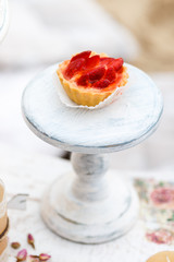 Sweet and delicious cake with strawberries on a stand. Shabby chic style