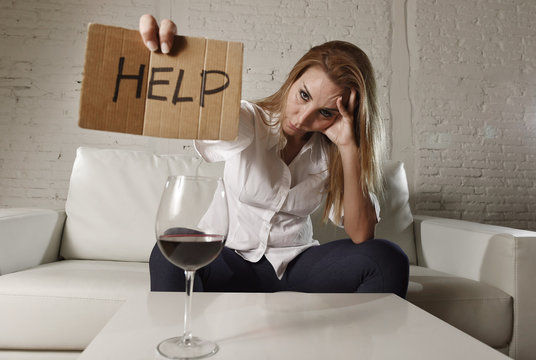 drunk alcoholic blond woman drinking alcohol asking for help holding message board wasted