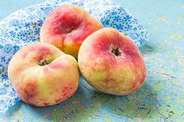 Three flat peaches