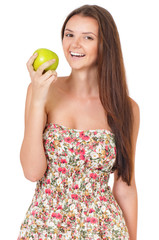 Beautiful teen girl with fresh green apple, isolated on white background. Young cheerful girl having fun.