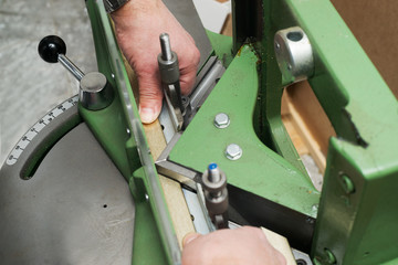 Craftsman working on frame in frameshop.