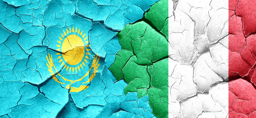Kazakhstan flag with Italy flag on a grunge cracked wall