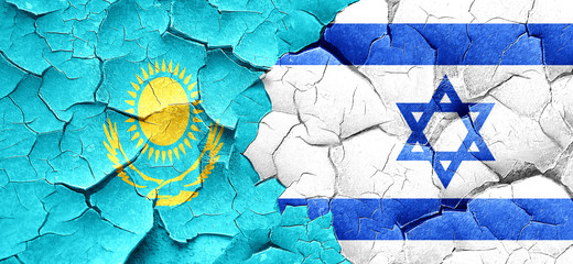 Kazakhstan flag with Israel flag on a grunge cracked wall