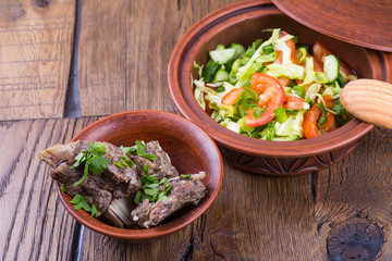 meat with vegetables on a wooden background