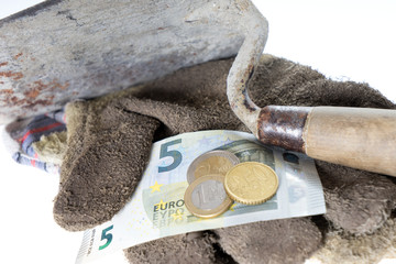 minimum wage / Brick trowel with work gloves and eight euro fifty