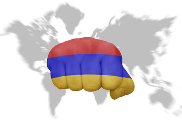 fist with the national flag of armenia on a world map background