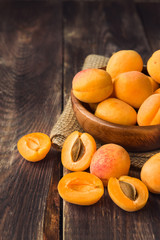 Fresh organic apricots in wooden bowl