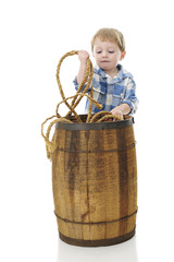 Little Cowboy Pulling Rope from a Barrel